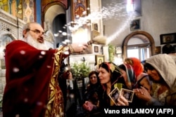 A priest gives a blessing during an Orthodox service in in Tbilisi.