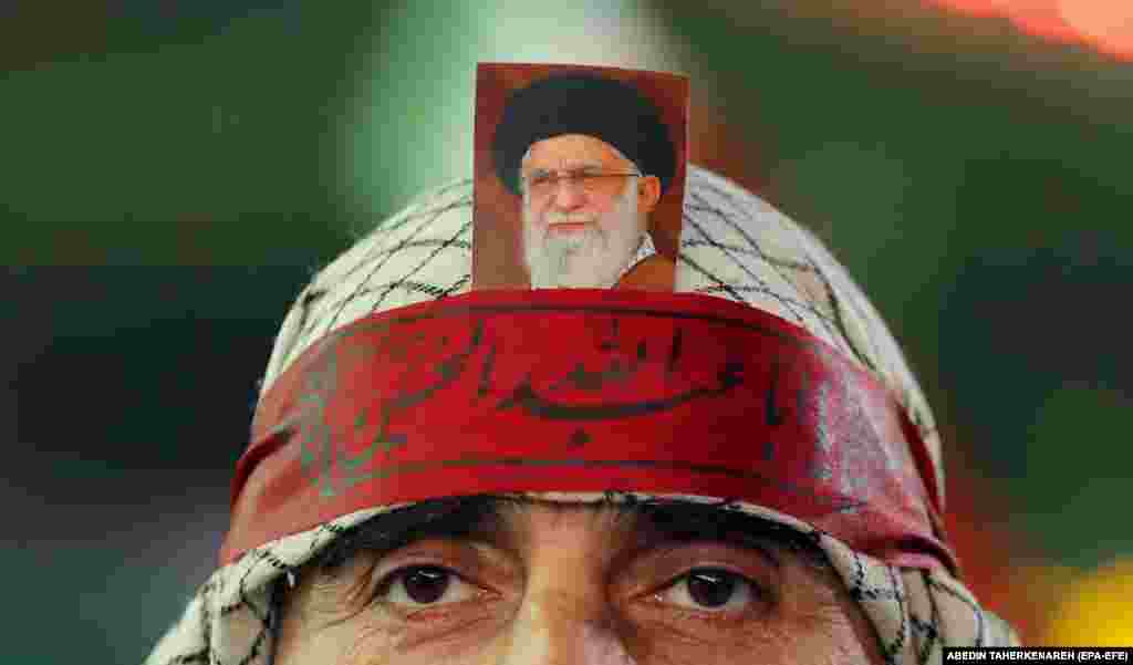 A man with a picture of Iranian Supreme Leader Ali Khamenei on his forehead participates in an anti-Israel demonstration in Palestine Square in Tehran.