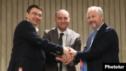 Armenia - Economy Minister Vahan Kerobian (center) shakes hands with representatives of Lydian Canada Ventures and the Eurasian Development Bank, February 22, 2023.