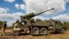 The Ukrainian military prepares to fire a self-propelled howitzer at Russian positions in eastern Ukraine.