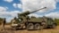 The Ukrainian military prepares to fire a self-propelled howitzer at Russian positions in eastern Ukraine.