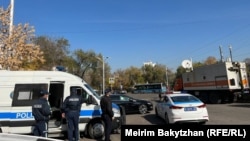 Полиция и автомобиль с надписью «Техникалық көмек» на парковке у места предполагаемого митинга. 25 октября 2023 года