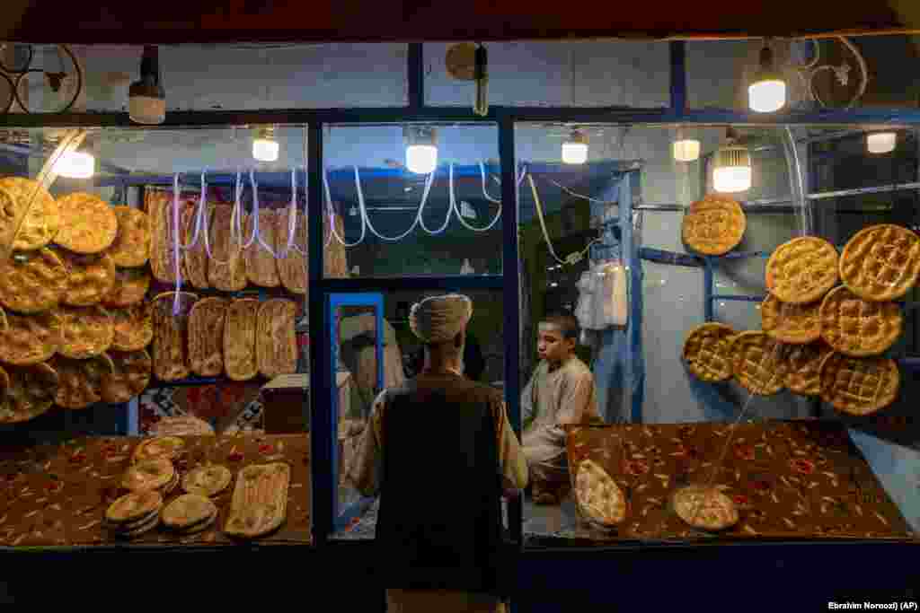 An Afghan man buys bread in downtown Herat.