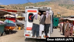 Relatives carry the bodies of slain victims in an ambulance after a bomb explosion at a mosque in Afghanistan's Badakhshan Province on June 8. 