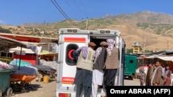 Relatives accompany the bodies of slain victims in an ambulance after an explosion at the Nabawi mosque in the Hesa-e-Awal area of Fayzabad district, Badakhshan Province, on June 8.