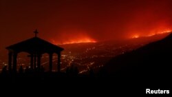 Pogled na vatru koja se pojavljuje iza planina nedaleko od evakuisanih sela, Tenerife, Španija, 20. avgust 2023.