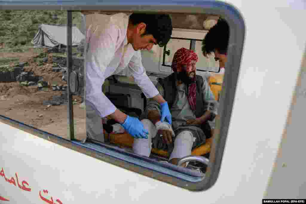 Haji Sarakha, a 48-year-old Afghan man who lost all of his family members in floods, receives treatment inside an ambulance. &nbsp;