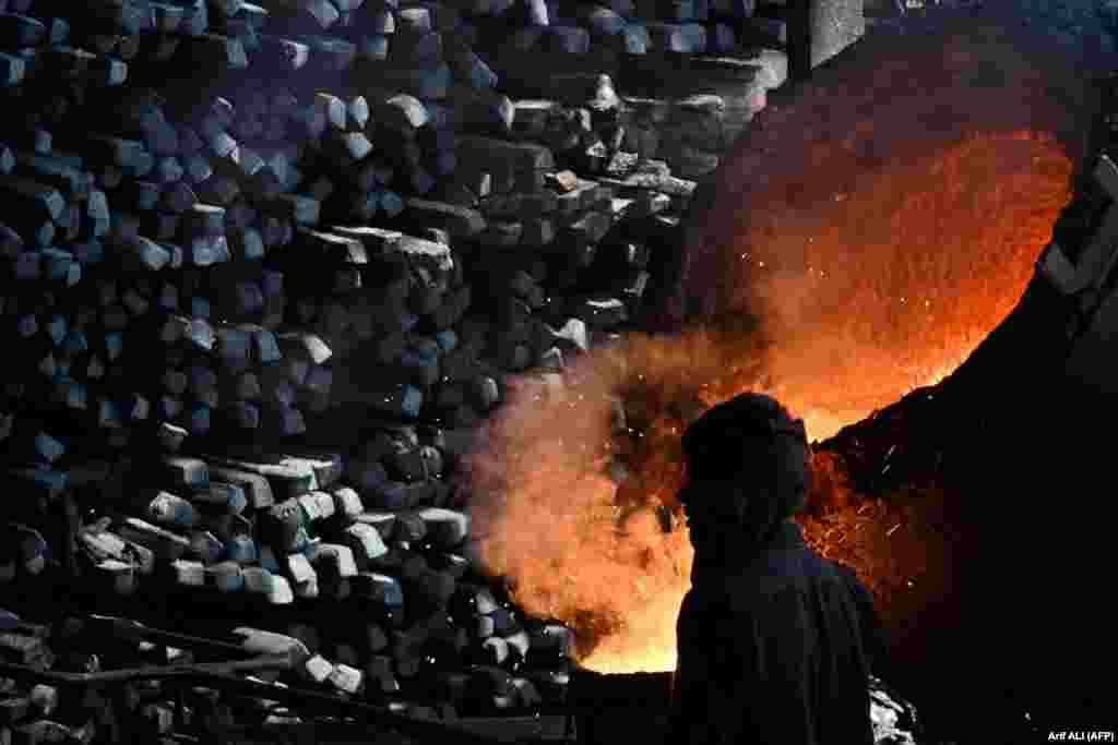A laborer works at an iron factory in Lahore, Pakistan.