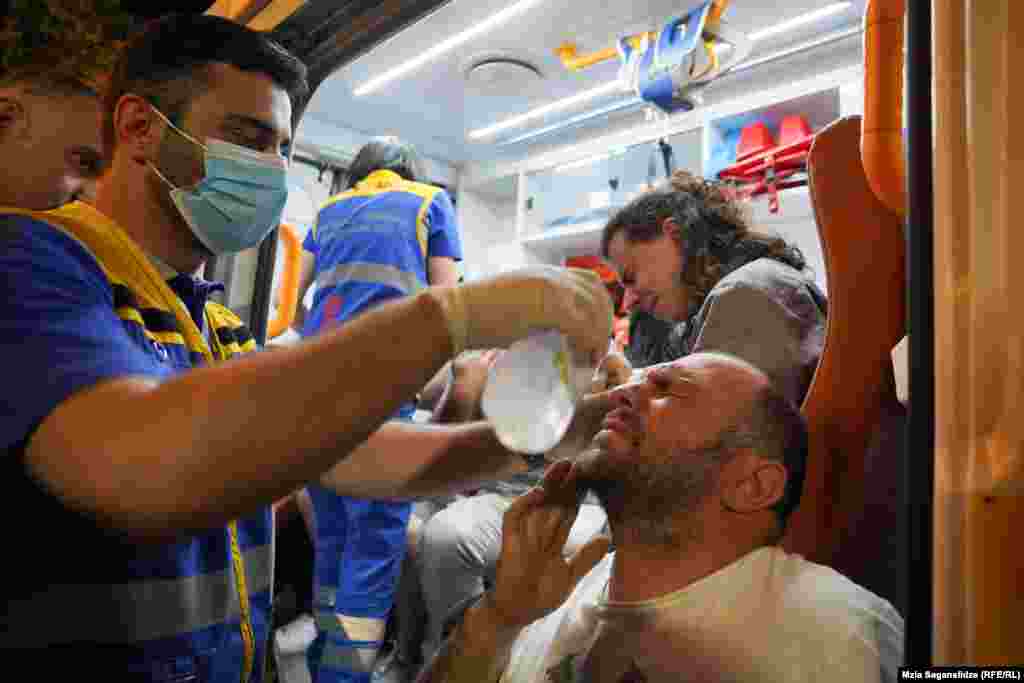 Medics flush the eyes of protestors who were exposed to tear gas. Police used tear gas and pepper spray to disperse crowds after they broke through security lines near the parliament building around midnight.