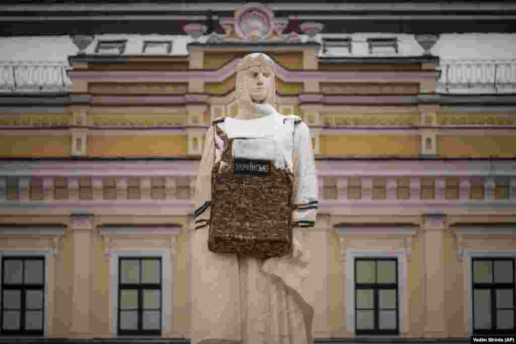 The statue of Grand Princess Olga of Kyiv is fitted with a mock flak jacket in the Ukrainian capital.