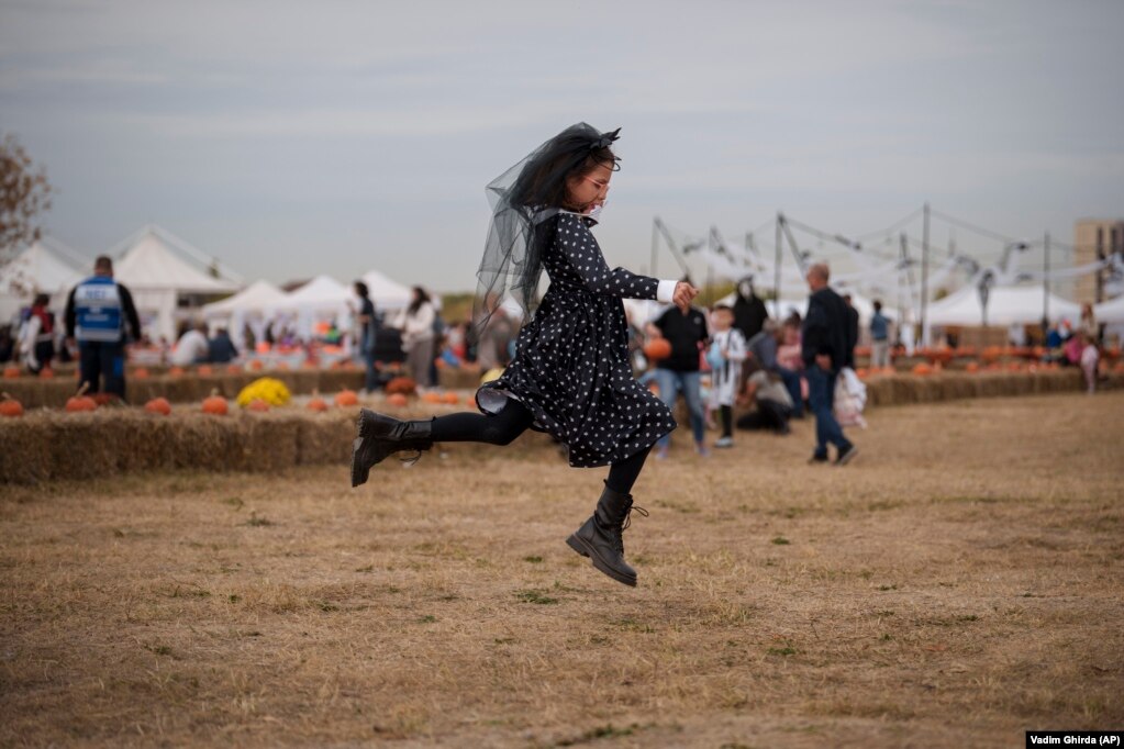 Una ragazza in costume salta lungo l'area del festival.
