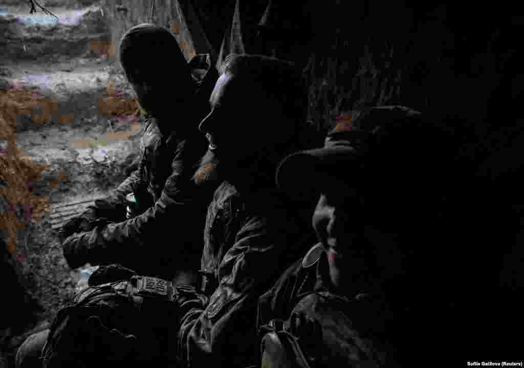 Ukrainian soldiers shelter at the front line. &nbsp;