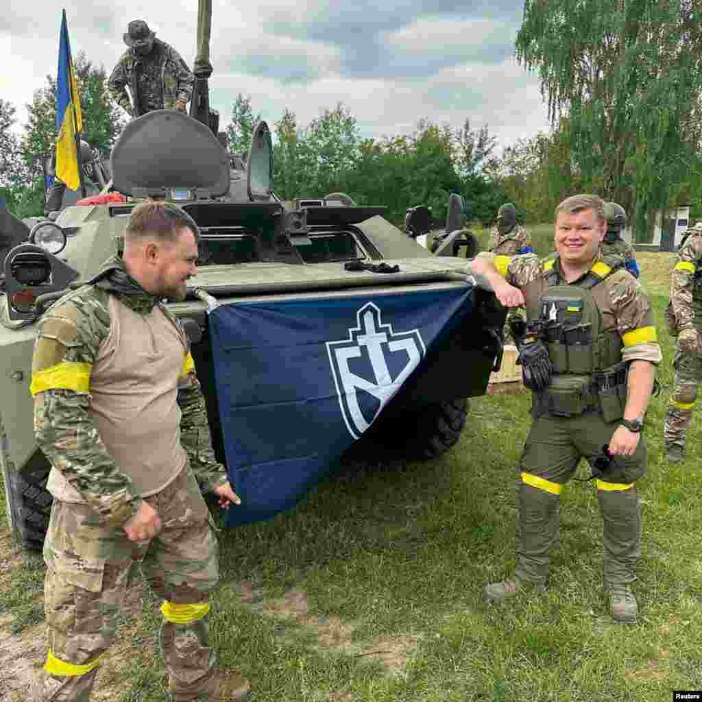 Members of the Russian Volunteer Corps display their flag in an image apparently taken inside Russian territory that was released on May 23.&nbsp; Michael Colborne, a journalist with the open-source investigative group Bellingcat, told Vice News&nbsp;that he immediately recognized some of the men allegedly involved in the raid as well-known neo-Nazis. &quot;These are people who have literally organized Hitler worship nights, written poems about Hitler, and lead bands whose names and songs are about Hitler,&quot; he said.