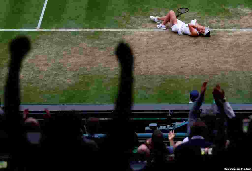 Ukraine&#39;s Elina Svitolina celebrates winning her fourth round match against Belarus&#39; Victoria Azarenka during Wimbledon at the All England Lawn Tennis and Croquet Club in London.