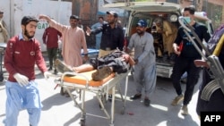 Volunteers carry a blast victim on a stretcher at a hospital in Quetta on September 29.
