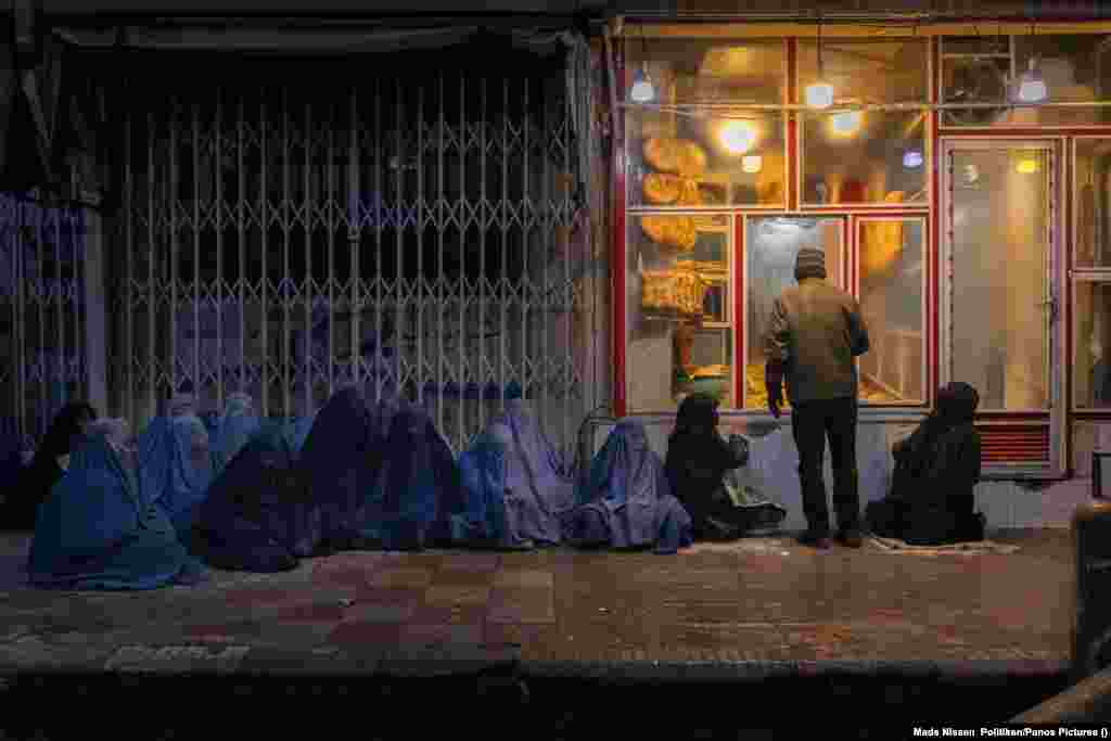 Women and children beg for bread outside a bakery in central Kabul on January 14, 2022. World Press Photo Story of the Year:&nbsp;The Price Of Peace In Afghanistan by&nbsp;Mads Nissen, Politiken/Panos Pictures