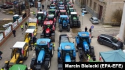 Polish farmers block a street during a protest in Szczecin on April 3 against what they call a flood of Ukrainian grain on the local market, which they say has depressed domestic grain prices. 