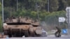 Israeli tanks are positioned near the border with Gaza in southern Israel on October 10. The White House says it has the military resources to support Israel in its war against Hamas and Ukraine. 