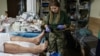 Ukraine -- Images showing combat medic Yana Rykhlitska at work. The 29-year-old was killed on March 3. 