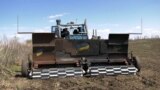 GRAB A Remote-Controlled Armored Tractor Hits The Mine-Strewn Fields Of Ukraine