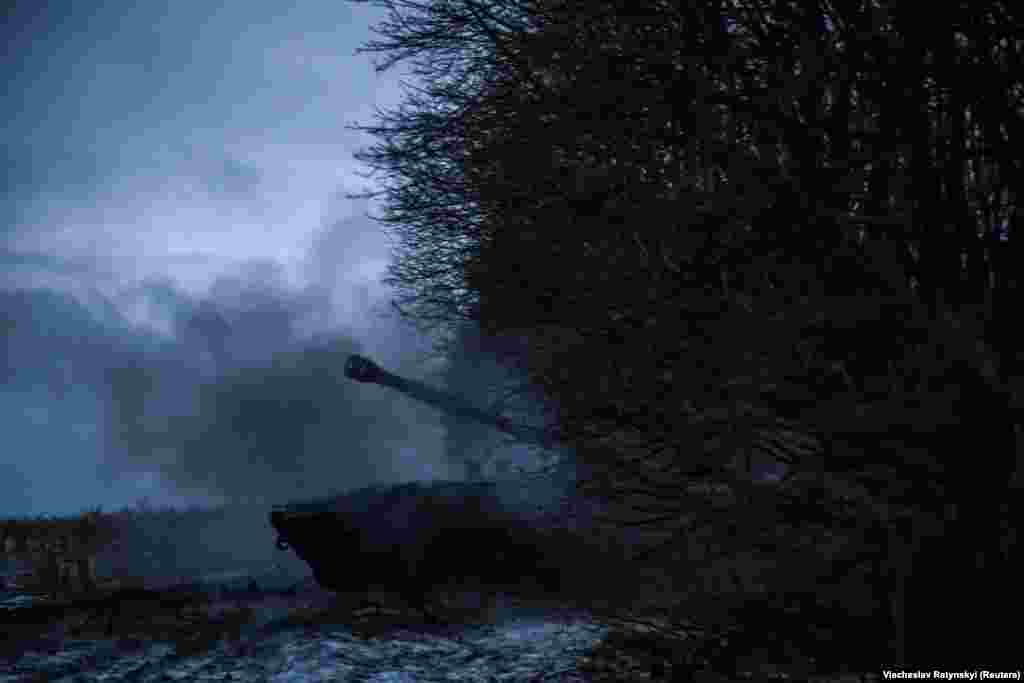 A cloud of smoke emanates from the gun after a shell is launched toward Russian positions. &nbsp;