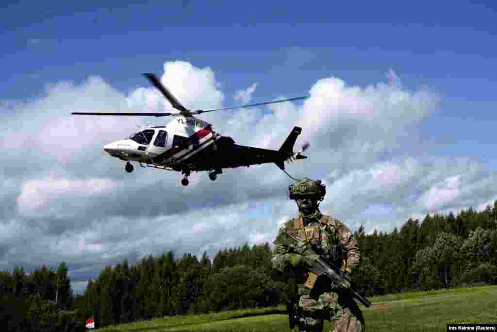 A Latvian State Border Guard helicopter takes off from Lidumnieki to inspect the area near the Belarusian-Latvian border on August 8. Latvia, Poland, and other countries on NATO&#39;s eastern flank have voiced concerns about a potential threat from Belarus, which now hosts thousands of troops belonging to the Wagner mercenary group.