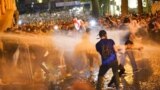 Georgia -- Protesters stand as water cannons are being used to disperse them during a rally to protest against a bill on "foreign agents"