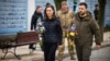 Ukrainian President Volodymyr Zelenskiy (right) and Finnish Prime Minister Sanna Marin attend a commemoration event for fallen Ukrainian soldiers in the war with Russia at the Wall of Remembrance in Kyiv on March 10. 