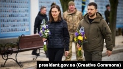 Ukrainian President Volodymyr Zelenskiy (right) and Finnish Prime Minister Sanna Marin attend a commemoration event for fallen Ukrainian soldiers in the war with Russia at the Wall of Remembrance in Kyiv on March 10. 