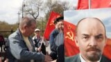 A portrait of Soviet founder Vladimir Lenin is seen as Russian communists attend a flower-laying ceremony at his mausoleum on the 154th anniversary of his birth, in Moscow on April 22.