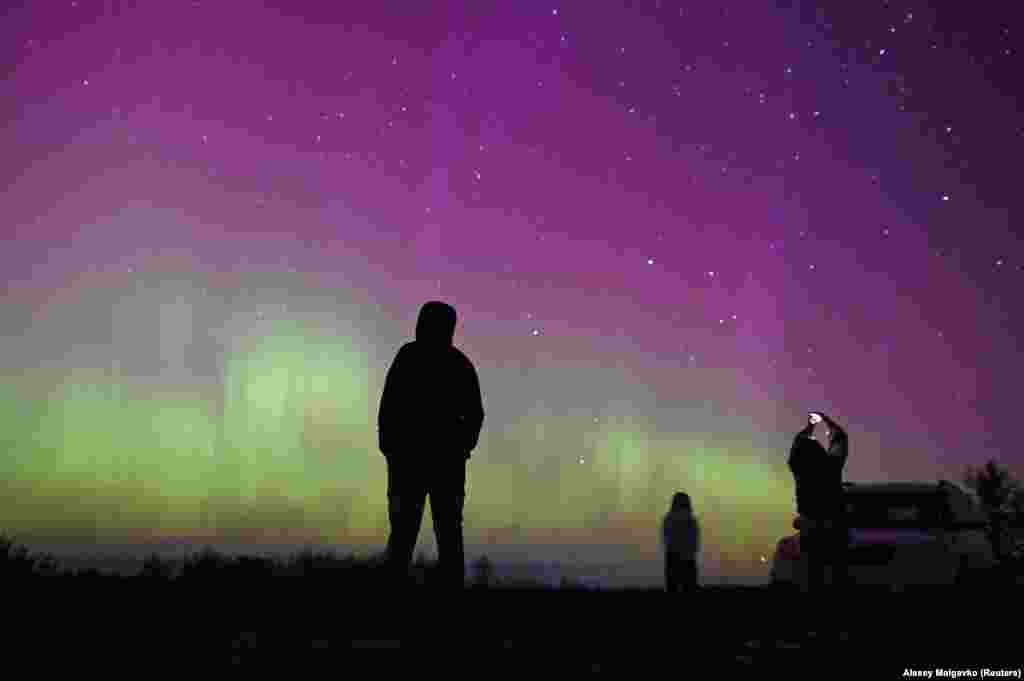  The Northern Lights illuminate the sky as people gather to watch the annual Perseid meteor shower near the village of Borodinka in Russia&#39;s Omsk region. &nbsp; 