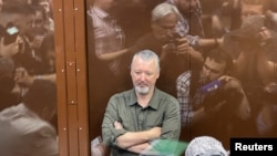 Russian nationalist Kremlin critic and former military commander Igor Girkin, also known as Igor Strelkov, who was charged with inciting extremist activity, sits in a glass defendants' cage during a court hearing in Moscow on July 21, 2023.