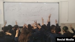 Female students pose without the mandatory hijab at a school in Iran on April 20.
