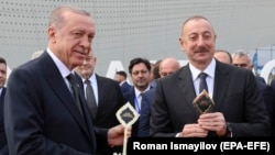 Turkish President Recep Tayyip Erdogan (L) and Azerbaijani President Ilham Aliyev attend a ceremony for the opening of a new international airport in Zangilan, one of the districts that Azerbaijan regained control of during the 2020 war in Nagorno-Karabakh. October 20, 2022.