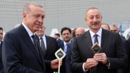 Turkish President Recep Tayyip Erdogan (left) and Azerbaijani President Ilham Aliyev attend an opening ceremony of the new international airport in Zangilan, Azerbaijan, on October 20, 2022.