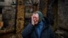 UKRAINE - Woman reacts as she commemorate a family who were killed by Russian drone strike in Kharkiv, Ukraine -- February 12, 2024