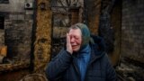 UKRAINE - Woman reacts as she commemorate a family who were killed by Russian drone strike in Kharkiv, Ukraine -- February 12, 2024