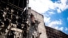 Workers clear rubble from the upper floors of a Ukrainian power plant damaged in a Russian attack on June 20.