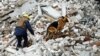 A rescuer works with a sniffer dog at the site of a destroyed building during a deadly Russian missile strike in Chernihiv on April 17.