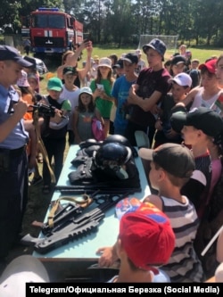 Ukrainian children are shown military weapons and other gear at a camp in Belarus.