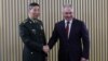 Russian Defense Minister Sergei Shoigu (right) shakes hands with his Chinese counterpart, Li Shangfu, during a meeting on the sidelines of a conference on international security in Moscow earlier this week. 