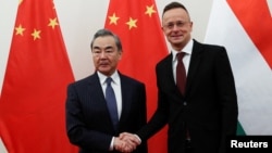 Петер Сиярто (справа) с бывшим главой МИД Китая Ван И, ныне курирующим внешнюю политику в ЦК Компартии Китая. Будапешт, 20 февраля 2023 года