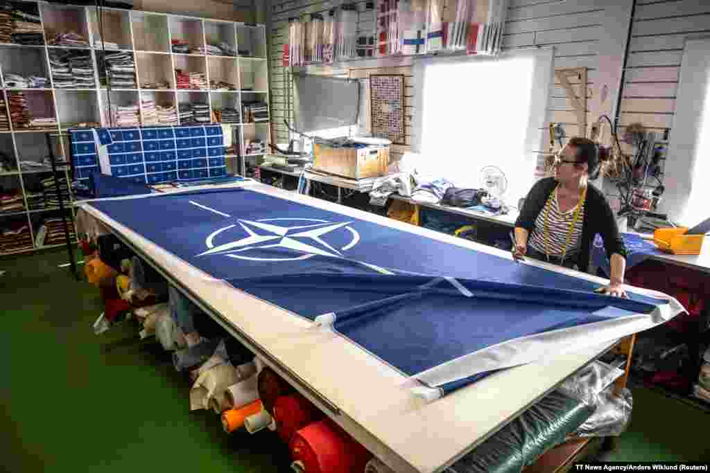 Seamstress Tove Lycke works on a NATO flag at a workshop near Stockholm, Sweden.&nbsp; Sweden formally joined NATO on March 7, two years after applying to join the military alliance in the wake of Russia&#39;s February 2022 invasion of Ukraine.&nbsp;