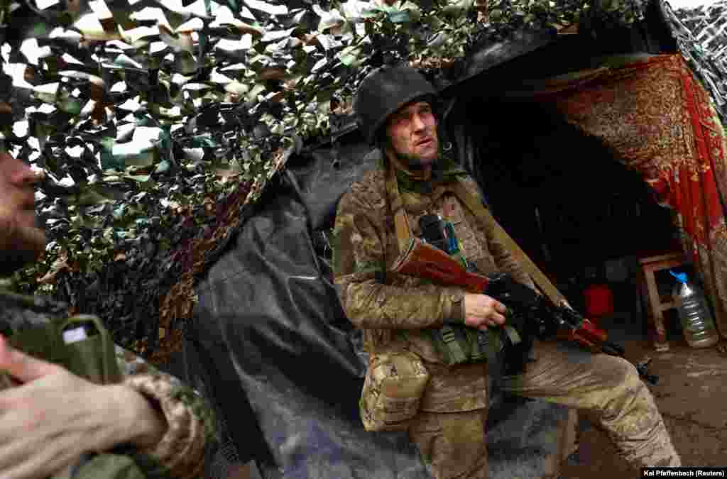 Another Ukrainian soldier keeps watch from his camouflaged trench position near New York, which lies some 35 kilometers to the north of the Russian-held city of Donetsk. &nbsp;