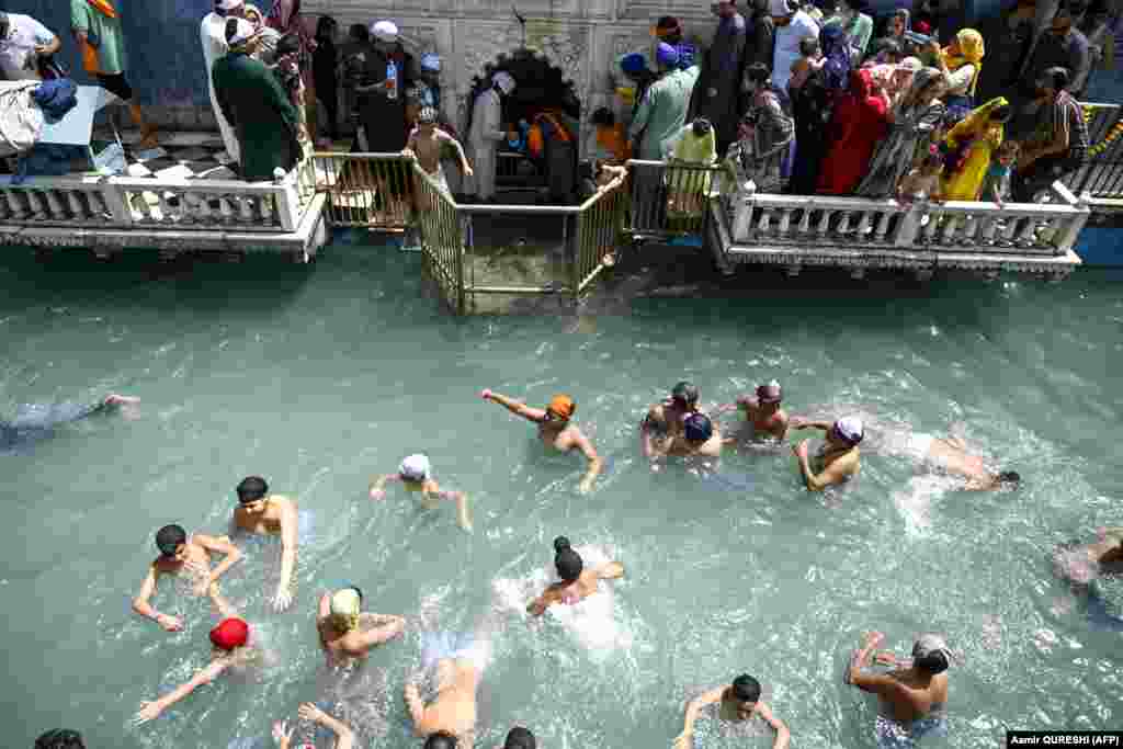 Sikh pilgrims take a dip during the Baisakhi, a spring harvest festival, in the Pakistani city of Hasan Abdal.&nbsp;
