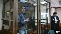 U.S. journalist Evan Gershkovich, arrested on espionage charges, stands inside a defendants' cage before a hearing to consider an appeal on his arrest at the Moscow City Court in Moscow on April 18.
