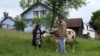 Philippine woman and Bosnian man making sustainable living near Prnjavor, Bosnia and Herzegovina, May 2023.