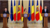 German Chancellor Olaf Scholz (left to right), Moldovan President Maia Sandu, and Romanian President Klaus Iohannis hold a press conference in Bucharest on April 3.