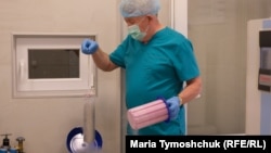 Stefan Khmil takes frozen embryos out of a liquid nitrogen tank at his fertility clinic in Lviv.