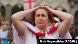 A Georgian demonstrator outside the Caucasus country's parliament on May 28, when lawmakers for the ruling Georgian Dream overrode President Salome Zurabishvili's veto of a controversial "foreign agent" law.
